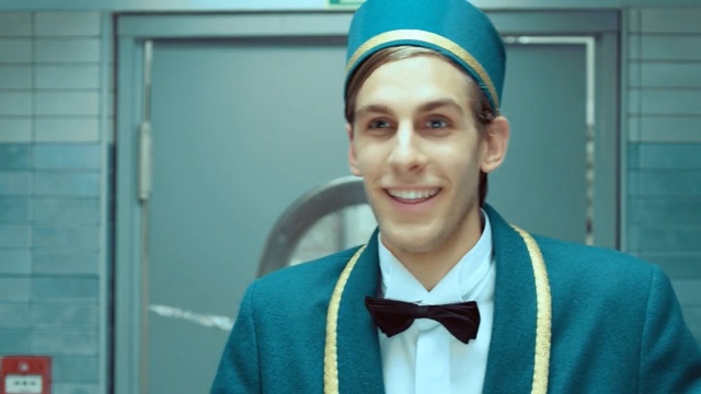 Video Reference: Smile, Headgear, Uniform, Fashion accessory, Tie, Bow tie, White-collar worker, Person