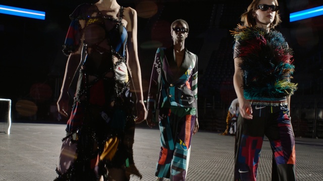 Video Reference: Fashion, Performance, Human, Runway, Fashion show, Fashion design, Fun, Event, Performance art, Costume design, Person, Holding, Standing, Man, Walking, Young, Woman, Girl, People, Room, Group, White, Clothing, Sunglasses, Human face, Dance