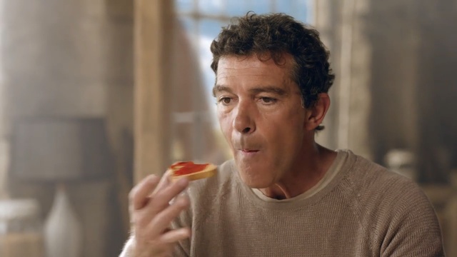 Video Reference: man, old man, guy, woman, people, kitchen, eat, sandwich, Person