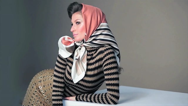 Video Reference: Outerwear, Scarf, Photography, Sitting, Neck, Fashion accessory, Ear, Person