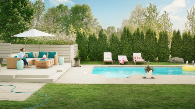 Video Reference: swimming pool, property, leisure, backyard, yard, estate, grass, house, lawn, real estate, Person