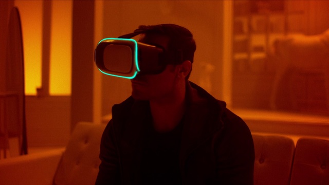 Video Reference: Eyewear, Glasses, Light, Cool, Fun, Photography, Sunglasses, Vision care, Room, Shadow, Person, Indoor, Man, Looking, Sitting, Front, Holding, Goggles, Dark, Wearing, Standing, Computer, Black, Laptop, Young, Shirt, Video, Red, Hat, Remote, Kitchen, Playing, Human face, Spectacles