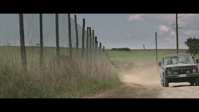Video Reference: car, land vehicle, vehicle, road, motor vehicle, ecosystem, mode of transport, grass, field, dust