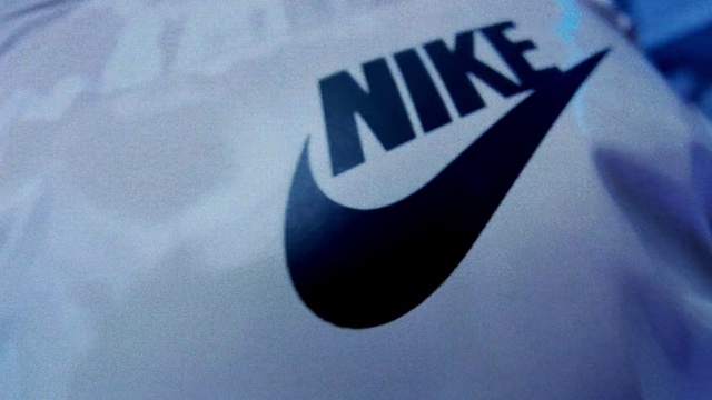 Video Reference: Sleeve, T-shirt, Font, Electric blue, Symbol, Automotive design, Brand, Graphics, Logo, Carmine