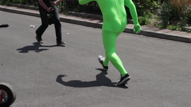 Video Reference: Green, Leggings, Footwear, Tights, Leg, Spandex, Trousers, Asphalt, Shoe, Human leg, Person