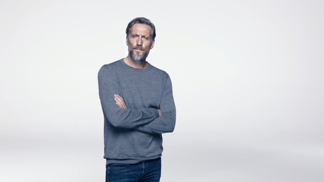 Video Reference: White, Blue, Standing, Shoulder, T-shirt, Sleeve, Facial hair, Neck, Outerwear, Beard, Person