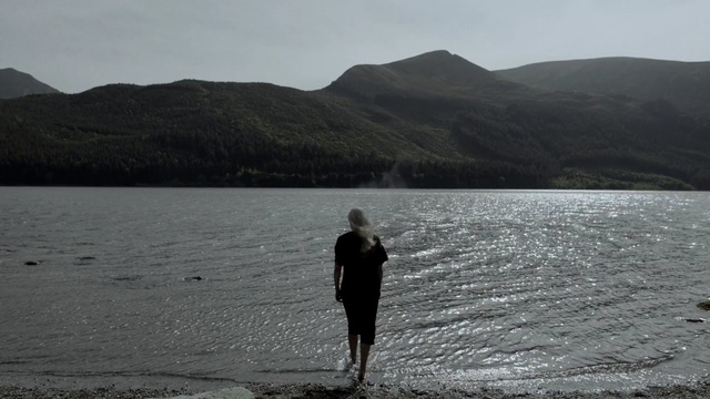 Video Reference: Body of water, Lake, Lake district, Loch, Shore, Sea, Standing, Water, Coast, Sound, Person