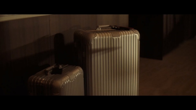 Video Reference: Lighting, Suitcase, Architecture, Baggage, Photography, Still life photography, Furniture, Table, Cylinder, Indoor, Sitting, Luggage, Black, White, Large, Room, Standing, Red, Cat, Man