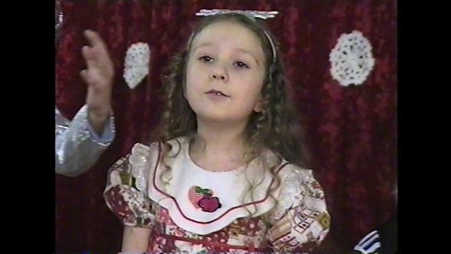 Video Reference: Cheek, Nose, Human, Smile, Textile, Long hair, Child, Gesture, Hair accessory, Neck