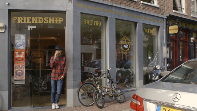 Video Reference: vehicle, street, building, retail, facade, city, window, service, Person