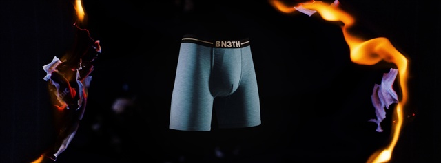 Video Reference: Clothing, Underpants, Briefs, Light, Shorts, Sportswear, Undergarment, Trunks, Fire, Person, Nature, Indoor, Table, Fireplace, Front, Man, Dark, Lit, Looking, Black, Sitting, Young, Standing, Holding, Wearing, Woman, Shirt, Red, Cake, Playing, Casual dress, Sleeve, Active shirt, Belt, Pocket