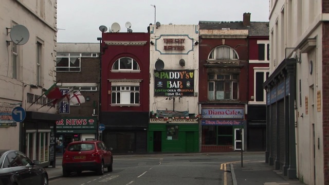 Video Reference: car, town, neighbourhood, family car, building, infrastructure, street, city, residential area, road, Person