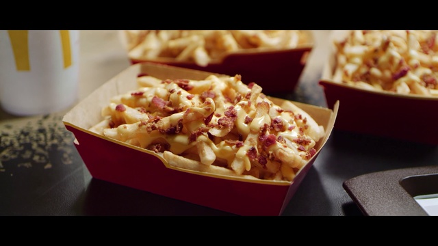 Video Reference: Dish, Food, Cuisine, Ingredient, Poutine, Comfort food, Junk food, Staple food, Produce, Side dish, Table, Indoor, Photo, Sitting, Different, Box, Front, Paper, Pasta, Red, Filled, Tray, Fries, Bowl, Plate, Toppings, Hot, Dog, Restaurant, Fast food, Baked goods, Snack, Pizza, Waffle, Dessert, Breakfast, Delicious, Meal, Belgian waffle