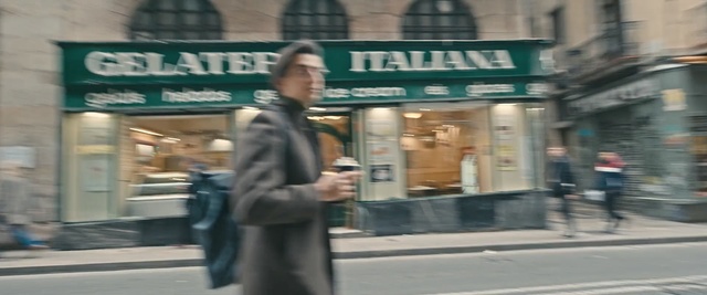 Video Reference: street, urban area, road, infrastructure, pedestrian, standing, city, lane, building, vehicle, Person