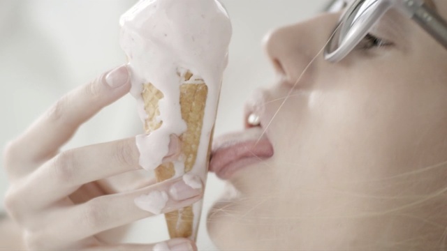 Video Reference: ice cream, dairy product, finger, ice cream cone, food, joint, cream, lick, licking