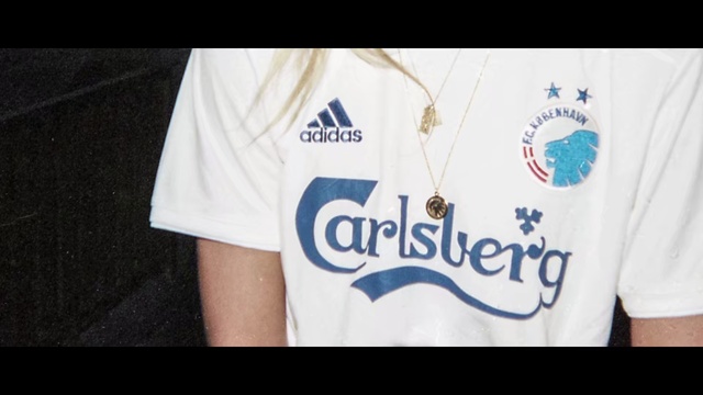 Video Reference: T-shirt, White, Clothing, Font, Top, Sleeve, Text, Shirt, Logo, Active shirt, Person
