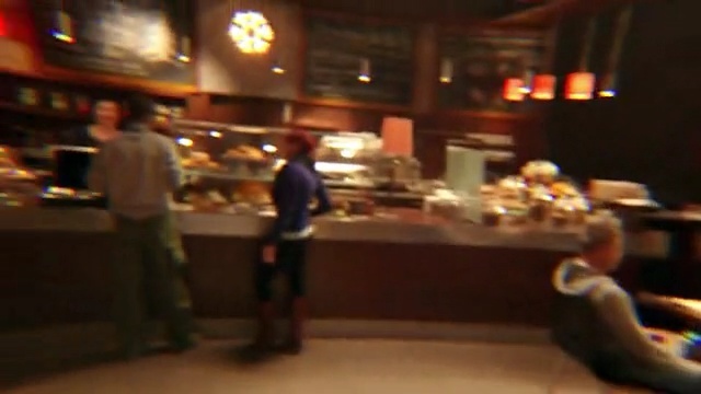 Video Reference: Restaurant, Buffet, Bar, Function hall, Food court, Building, Banquet, Event, Meal, Diner, Indoor, Person, Table, Food, Sitting, Preparing, Man, Woman, Pizza, Kitchen, Counter, Standing, People, Glasses, Large, Room, Group, Living, Plate, Fast food, Menu, Clothing