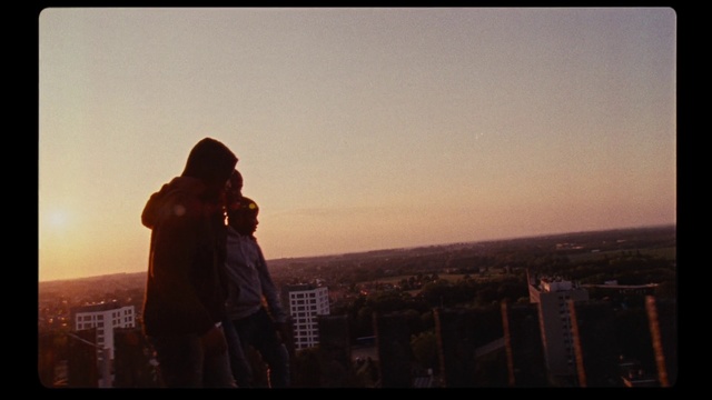 Video Reference: Sky, Photograph, Urban area, Atmospheric phenomenon, Horizon, Snapshot, Cloud, City, Skyline, Photography, Outdoor, Standing, Man, Front, Monitor, Sunset, Computer, Flying, Field, Large, Holding, Air, Street, Sign, Person, Text, Clothing