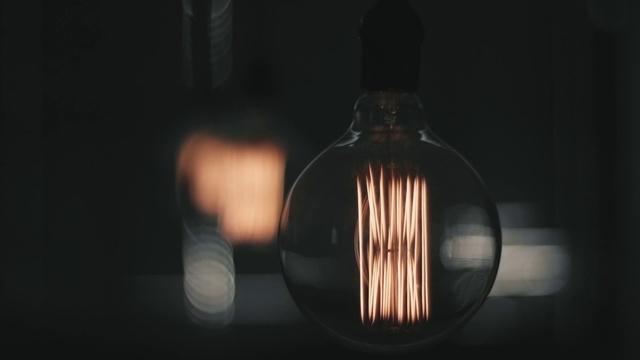 Video Reference: Incandescent light bulb, Lighting, Light, Still life photography, Light fixture, Darkness, Lamp, Light bulb, Facial hair, Lighting accessory