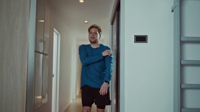 Video Reference: Shoulder, Standing, Room, Arm, Door, Joint, Floor, House, Person, Indoor, Building, Man, Front, Holding, Looking, Woman, Doorway, Young, Mirror, Refrigerator, Posing, Wearing, Phone, Shirt, White, Kitchen, Blue, Wall, Clothing, Human face, Smile, Trousers