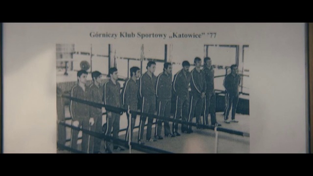 Video Reference: Photograph, White, Text, Snapshot, Monochrome photography, Font, Standing, Black-and-white, Iron, Photography, Person, Indoor, Photo, Man, Table, Group, Different, Room, People, Woman, Display, Clothing