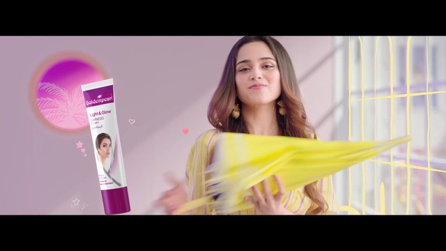 Video Reference: Hair, Face, Skin, Beauty, Hair dryer, Pink, Violet, Yellow, Lip, Material property, Person, Indoor, Table, Woman, Sitting, Holding, Man, Girl, Orange, White, Young, Colorful, Food, Standing, Display, Game, Human face, Smile, Clothing, Text, Dress, Lipstick