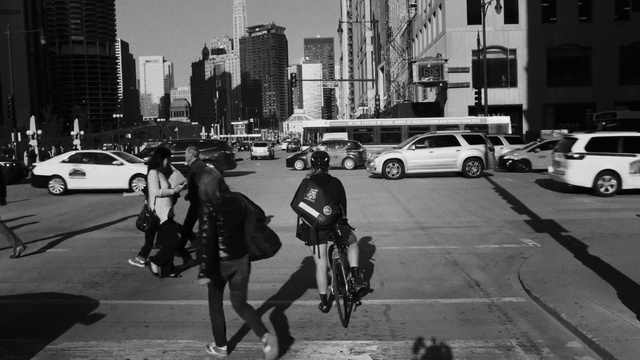 Video Reference: Vehicle, Urban area, Street, Motor vehicle, Mode of transport, Lane, Snapshot, Bicycle, Black-and-white, Road, Person