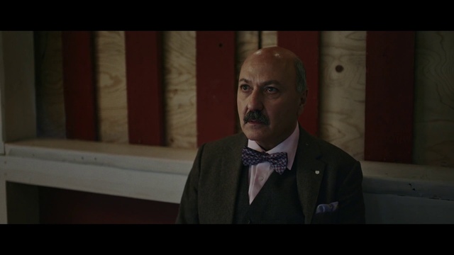 Video Reference: Suit, Photograph, Speech, Public speaking, Facial hair, Head, Formal wear, Tuxedo, Moustache, Snapshot