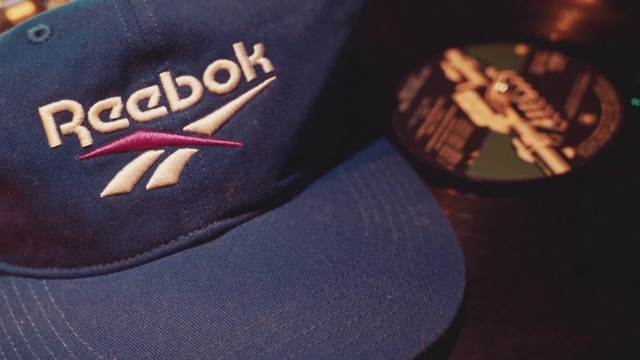 Video Reference: Cap, Baseball cap, Headgear, Footwear, Hat, Trucker hat, Fashion accessory, Shoe, Brand