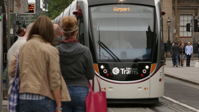 Video Reference: transport, tram, vehicle, mode of transport, public transport, passenger, street, pedestrian, Person