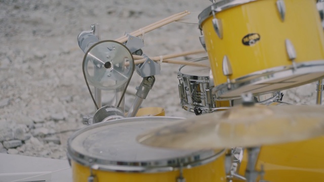 Video Reference: drum, yellow, musical instrument, drums, snare drum, tom tom drum, percussion, drumhead, percussion accessory, bass drum, Person