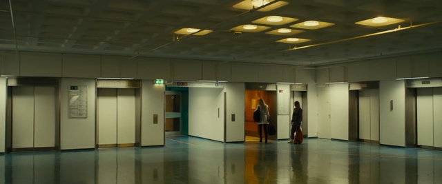 Video Reference: Building, Ceiling, Lobby, Hall, Room, Floor, Flooring, Interior design, Indoor, Kitchen, Standing, Table, Area, Sitting, Large, Empty, White, Man, People, Wall, Person, Door