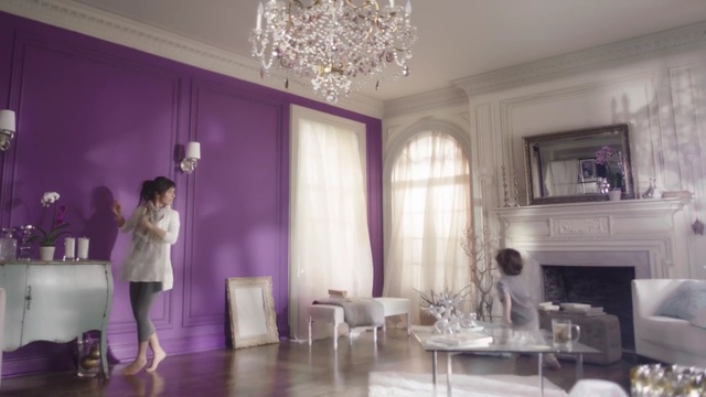 Video Reference: room, purple, interior design, property, living room, ceiling, home, furniture, function hall, dining room, Person