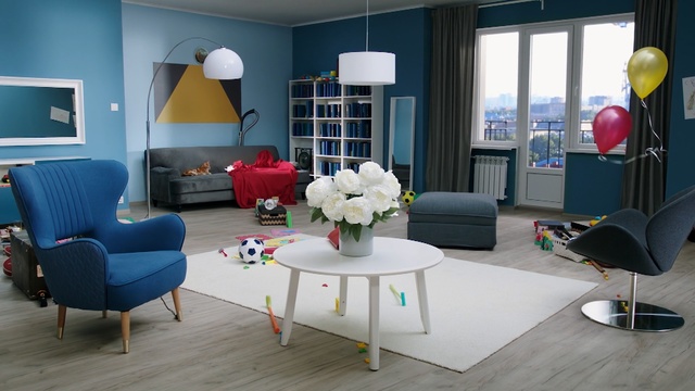Video Reference: blue, living room, room, interior design, table, furniture, home, chair, house, waiting room, Person