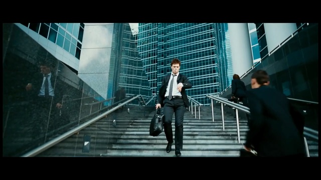 Video Reference: Standing, Gentleman, Snapshot, Metropolitan area, Male, Urban area, Photography, Architecture, Metropolis, White-collar worker, Person, Building, Man, Woman, Sidewalk, Walking, Holding, Young, Girl, Riding, Suit, Court, City, Playing, Doing, Street, Board, Suitcase, Luggage, Game, People, Clothing, Skyscraper, Footwear