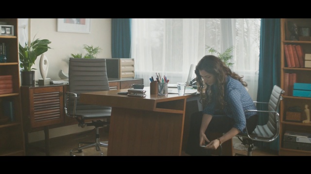 Video Reference: Furniture, Sitting, Desk, Room, Table, Eyewear, Interior design, Plant, Chair, Window