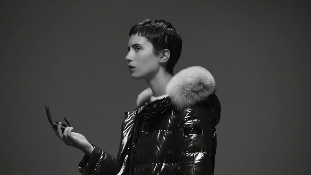 Video Reference: Black, Lady, Black-and-white, Standing, Fashion, Monochrome, Photography, Monochrome photography, Model, Hand, Person, Indoor, Holding, Woman, Looking, Man, Young, Front, Wearing, Posing, White, Girl, Shirt, Suit, Bear, Video, Phone, Stuffed, Remote, Room, Wall, Human face, Clothing, Portrait, Arm