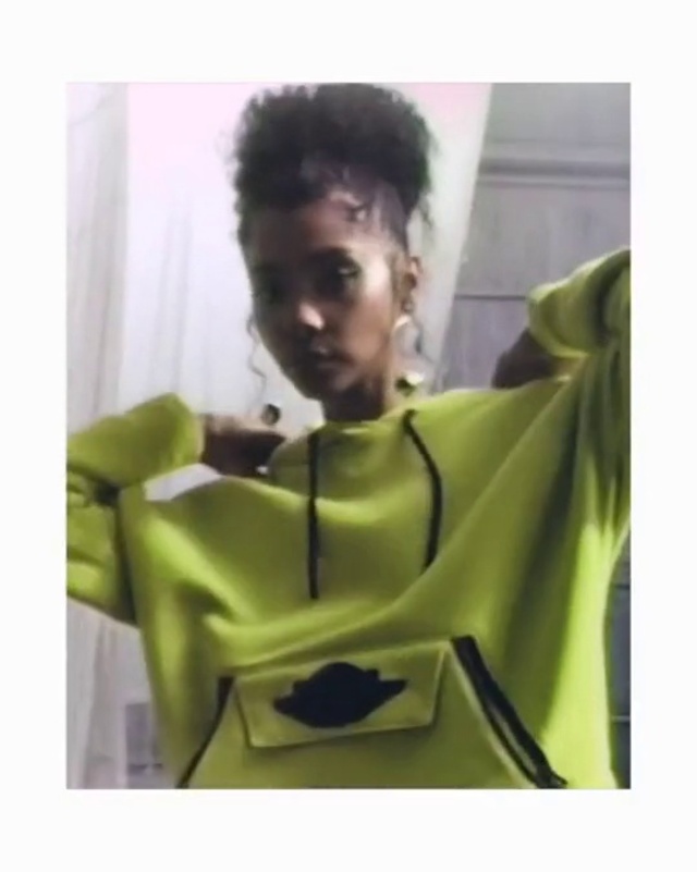 Video Reference: Yellow, Afro, Shoulder, Black hair, Photography, T-shirt, Neck, Sleeve, Wig, Lace wig
