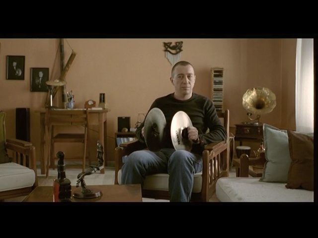 Video Reference: Photograph, Room, Sitting, Living room, Snapshot, Furniture, Arm, Musical instrument, Chair, Interior design, Person