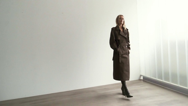 Video Reference: White, Standing, Clothing, Fashion, Coat, Shoulder, Trench coat, Outerwear, Joint, Footwear