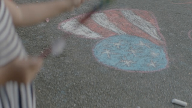 Video Reference: Chalk, Floor, Hand, Road surface, Asphalt, Sand, Art, Person, Sitting, Young, Woman, Boy, Girl, Table, Man, Holding, Laying, Wearing, Standing, Ball, Cat, White, Swinging, Bird, Playing, Phone, Room, Bat, Player, Baseball, Plate, Horse