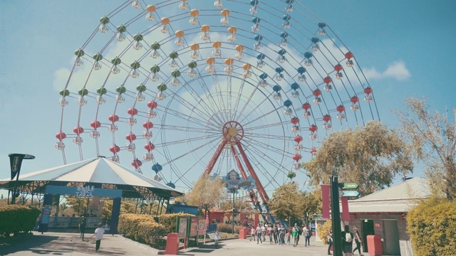 Video Reference: Ferris wheel, Amusement ride, Amusement park, Tourist attraction, Fair, Recreation, Fun, Park, Sky, Nonbuilding structure
