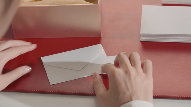 Video Reference: Paper, Envelope, Pink, Construction paper, Material property, Paper product, Hand, Art