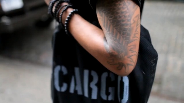 Video Reference: Black, Arm, Tattoo, Street fashion, Hand, Joint, Leg, Footwear, Human body, Finger