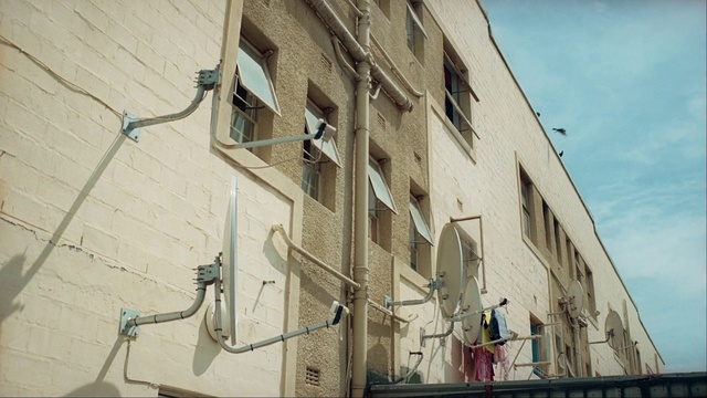 Video Reference: Wall, Architecture, Street light, Facade, Building, Urban area, Neighbourhood, House, Electrical wiring, Wire