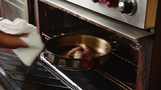 Video Reference: Food, Cooking, Dish, Cuisine, Cookware and bakeware, Recipe, Baking, Ingredient, Indoor, Cabinet, Person, Oven, Stove, Kitchen, Steel, Pot, Pan, Stainless, Man, Door, Pulling, Cooked, Woman, Hot, Wok, Frying pan, Home appliance, Gas stove, Sink, Pan frying, Barbecue grill, Outdoor grill rack & topper, Sauta pan, Outdoor grill, Cooktop, Kitchen stove, Microwave oven, Grilling, Saucepan, Stock pot, Barbecue, Countertop, Karahi, Record player, Putting, Slow cooker, Fresh, Kitchen appliance