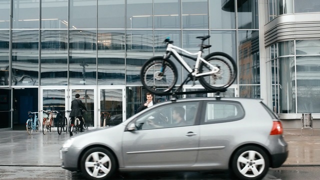 Video Reference: motor vehicle, car, vehicle, automotive design, wheel, volkswagen, automotive wheel system, building, hatchback, rim, Person