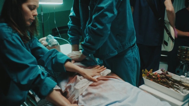 Video Reference: Medical procedure, Surgeon, Operating theater, Scrubs, Medical, Patient, Room, Service, Medical assistant, Hand, Person, Indoor, Woman, Holding, Table, Food, Standing, Man, Young, People, Girl, Cake, Playing, Shirt, Group, Blue, White, Plate, Game, Medical equipment, Baby, Medical glove, Health care, Surgery, Hospital, Health care provider, Nursing, Clinic