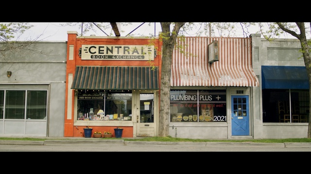 Video Reference: town, neighbourhood, house, facade, residential area, building, real estate, city, window, advertising, Person