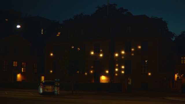 Video Reference: Night, Sky, Darkness, Light, Lighting, Street light, Automotive lighting, Midnight, Evening, Mode of transport, Outdoor, Building, Road, Green, Street, Track, Traffic, Train, Red, City, White, Large, Stop, Yellow, Water, Dark, Highway